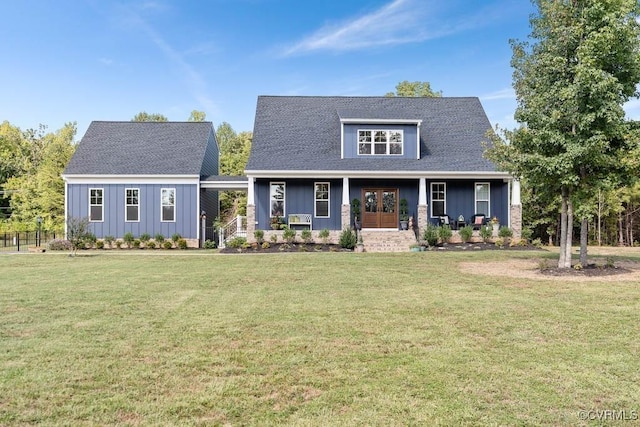 view of front of property with covered porch, board and batten siding, and a front yard