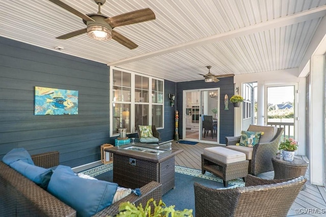 view of patio featuring ceiling fan, outdoor lounge area, and a wooden deck