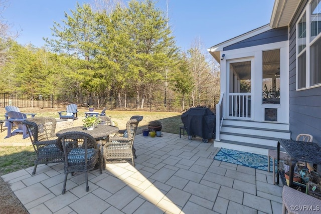 view of patio with outdoor dining area, grilling area, and a fenced backyard