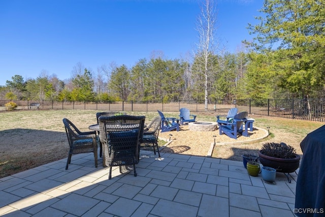 view of patio / terrace with an outdoor fire pit, outdoor dining area, and a fenced backyard