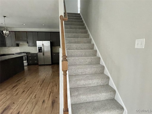 stairs featuring baseboards and wood finished floors