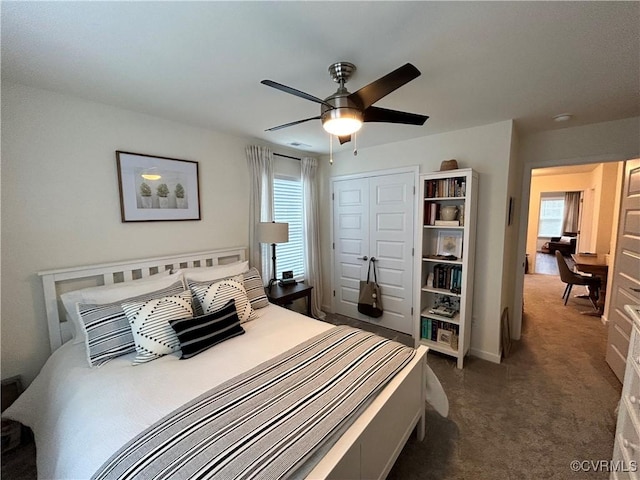 carpeted bedroom featuring visible vents, a ceiling fan, and a closet