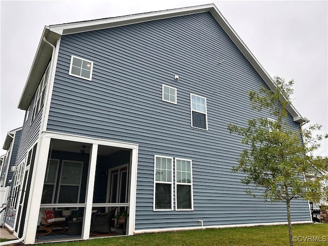 view of home's exterior with a sunroom