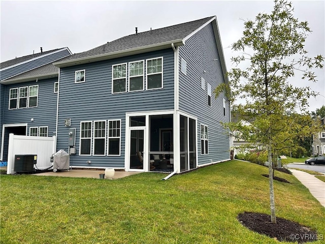 back of property with a patio area, a sunroom, central AC, and a yard