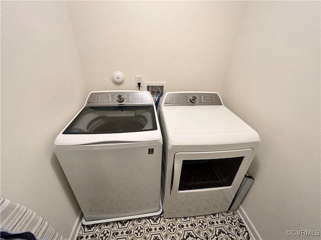 laundry area featuring laundry area, tile patterned flooring, baseboards, and washer and dryer