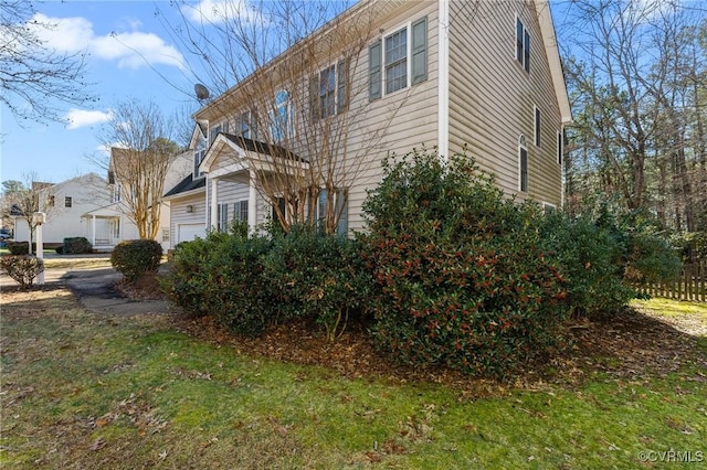 view of property exterior with a lawn