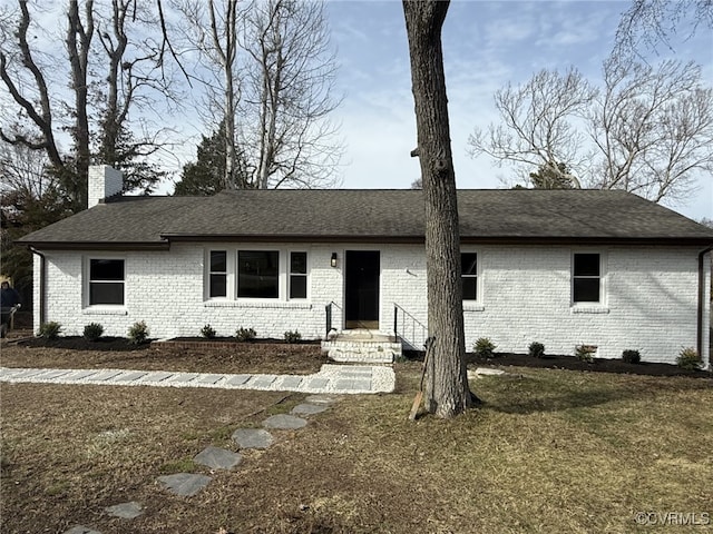 ranch-style home with a front lawn