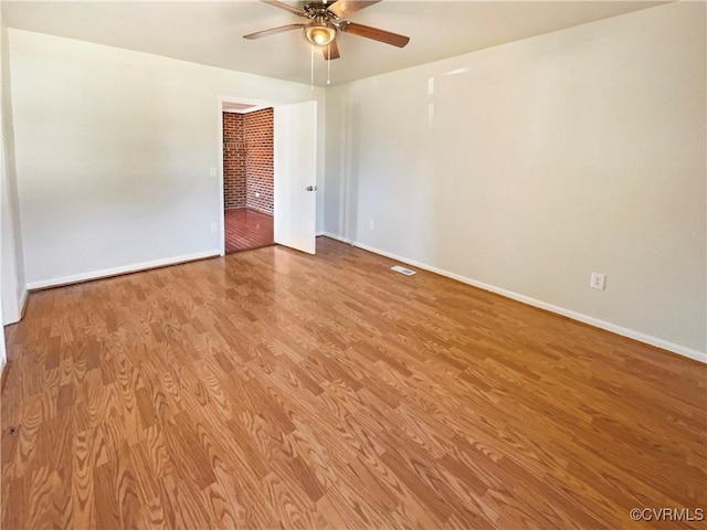 empty room featuring ceiling fan and light wood-type flooring