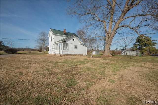 view of home's exterior with a yard