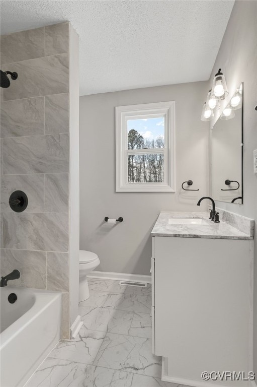 full bathroom featuring tiled shower / bath combo, toilet, a textured ceiling, and vanity