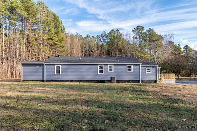 rear view of property with a yard