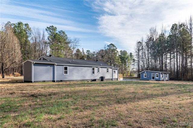 rear view of property with a yard