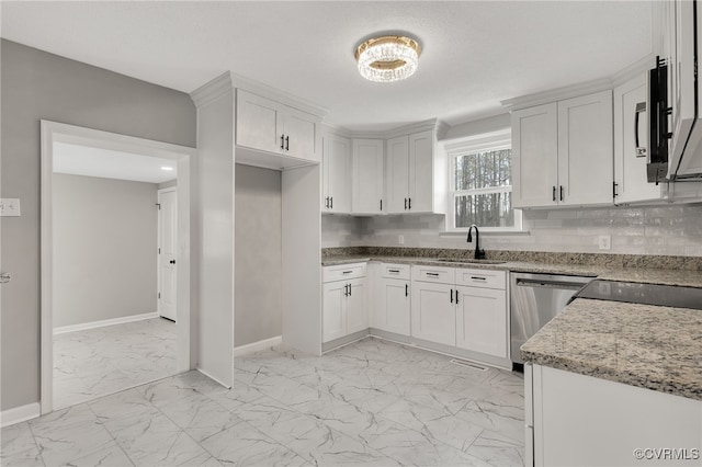 kitchen with dishwasher, sink, light stone counters, and white cabinets