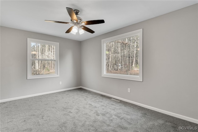 carpeted spare room with ceiling fan