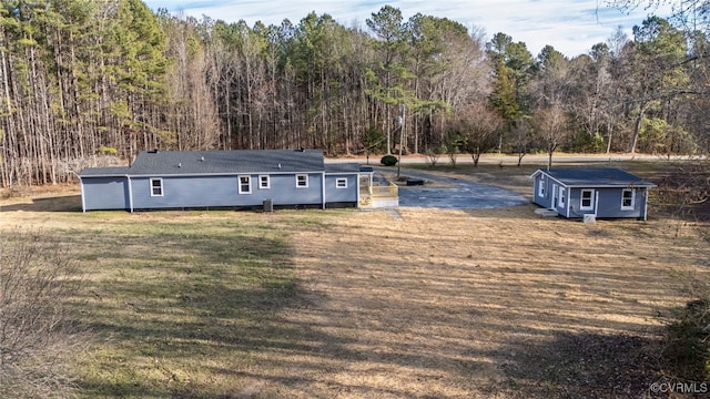 view of front of home with an outbuilding and a front yard