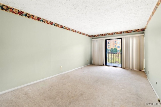 carpeted spare room with a textured ceiling