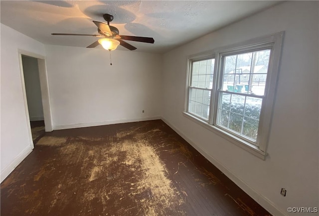 spare room with a healthy amount of sunlight and ceiling fan