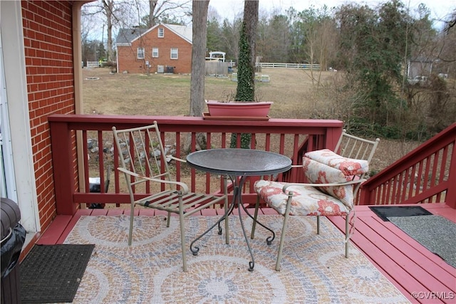 wooden deck featuring a yard