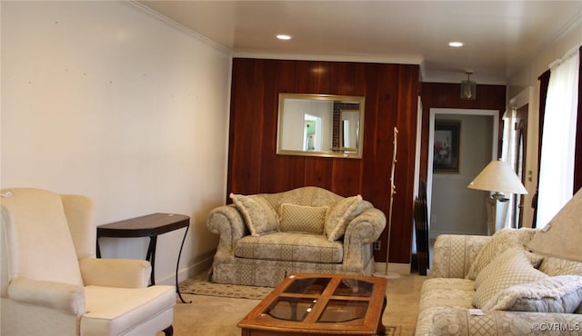 carpeted living room featuring wooden walls, recessed lighting, and ornamental molding