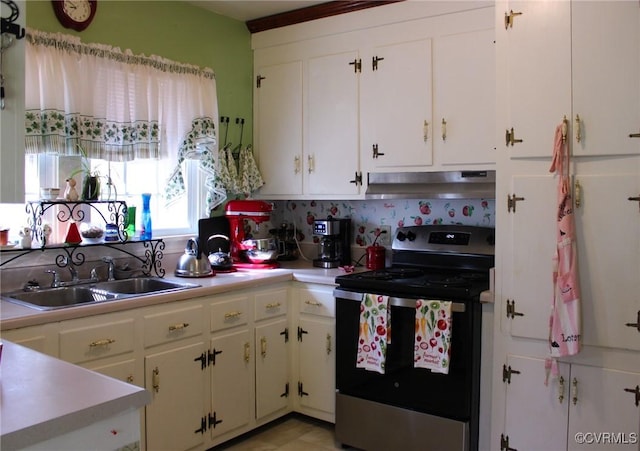 kitchen featuring under cabinet range hood, stainless steel range with electric cooktop, light countertops, and a sink