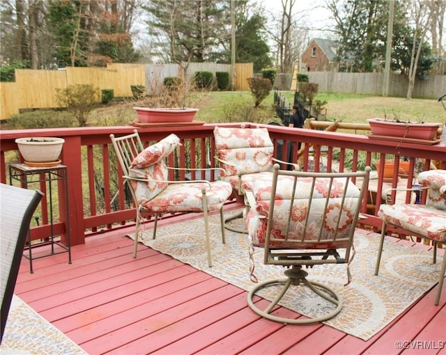 deck with a yard and a fenced backyard