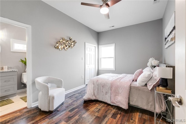 bedroom featuring ceiling fan, ensuite bath, dark hardwood / wood-style floors, and a closet