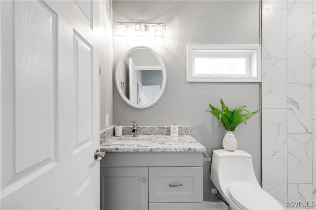 bathroom featuring toilet and vanity