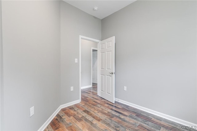 unfurnished room featuring dark hardwood / wood-style flooring