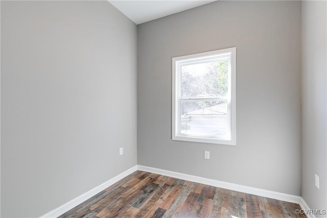 spare room with dark wood-type flooring