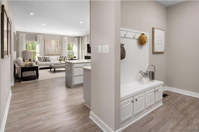 hallway with light hardwood / wood-style floors