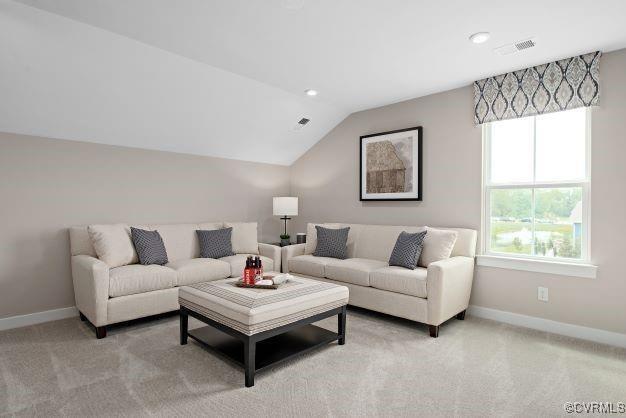 carpeted living room with lofted ceiling