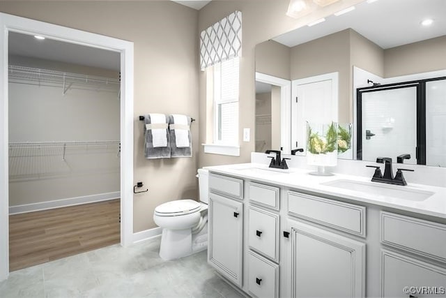 bathroom with vanity, an enclosed shower, and toilet