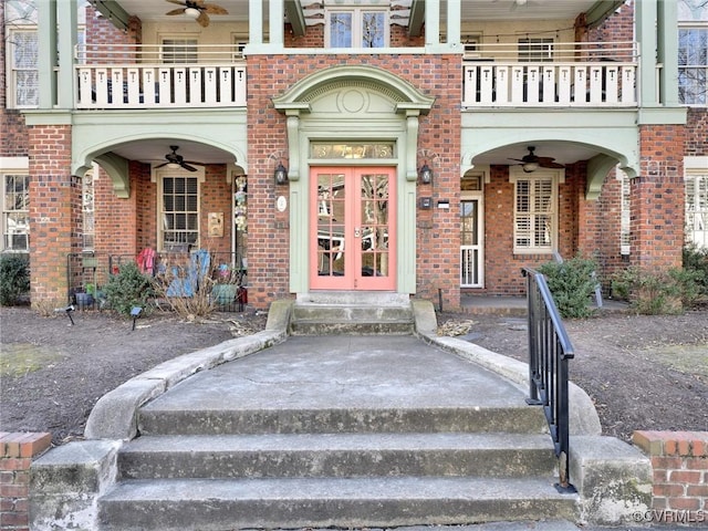 entrance to property featuring french doors, ceiling fan, and a balcony