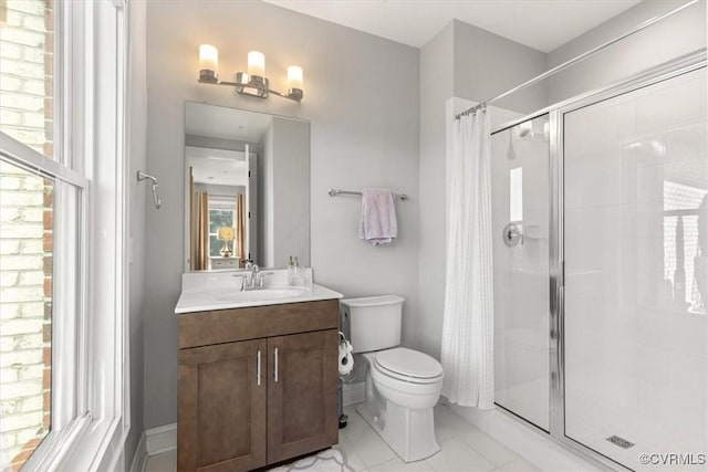 bathroom featuring toilet, a stall shower, and vanity