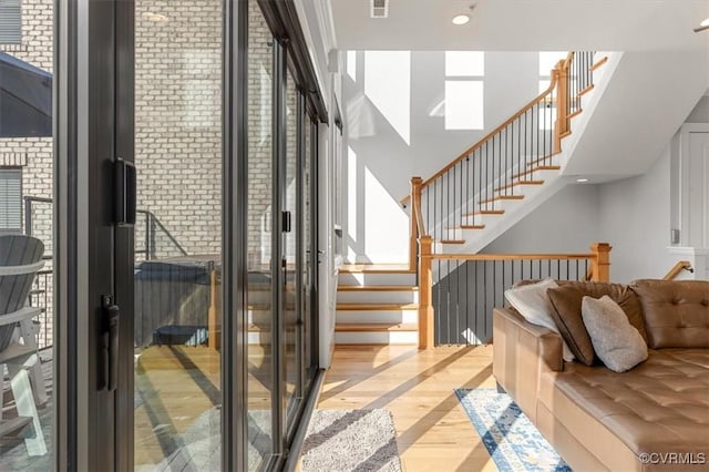 interior space with light wood finished floors, stairs, visible vents, and recessed lighting