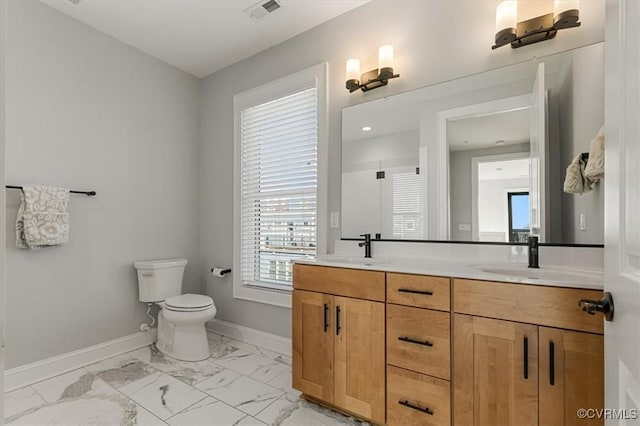 full bath with a sink, visible vents, baseboards, marble finish floor, and double vanity