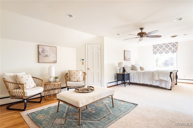 bedroom with baseboard heating, ceiling fan, vaulted ceiling, and hardwood / wood-style flooring