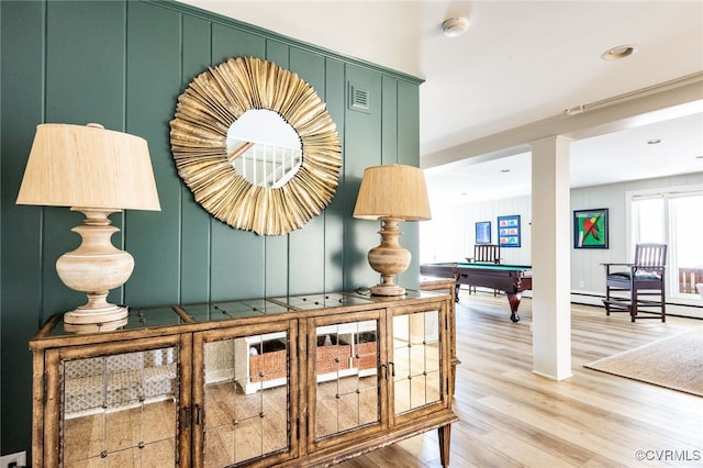 hallway featuring hardwood / wood-style floors and baseboard heating