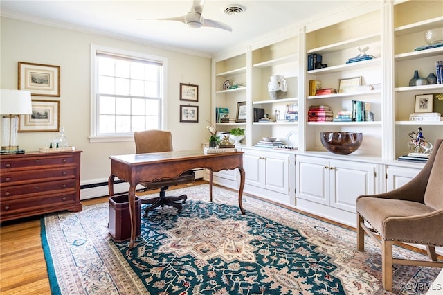 office area with light wood-type flooring, built in shelves, a baseboard heating unit, ceiling fan, and crown molding