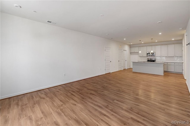 unfurnished living room featuring light wood-type flooring