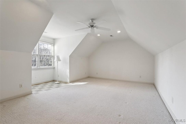 additional living space featuring light carpet, baseboards, lofted ceiling, ceiling fan, and recessed lighting