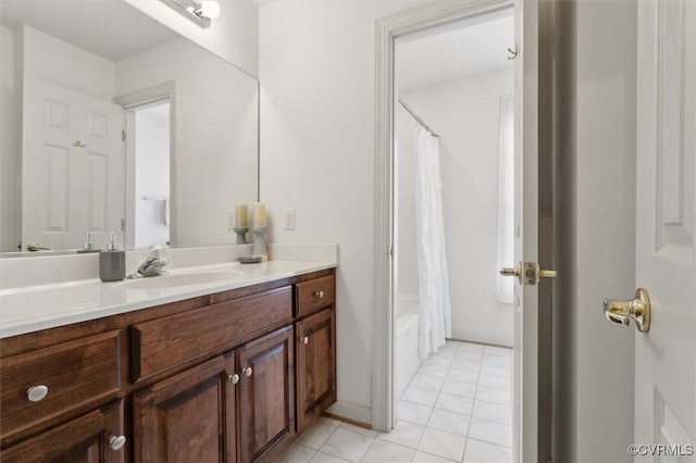 full bathroom with shower / bath combo, tile patterned flooring, and vanity