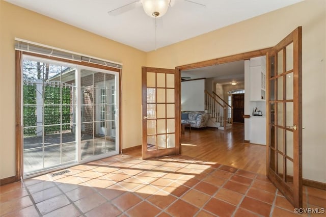 doorway to outside featuring stairs, french doors, a ceiling fan, and tile patterned floors