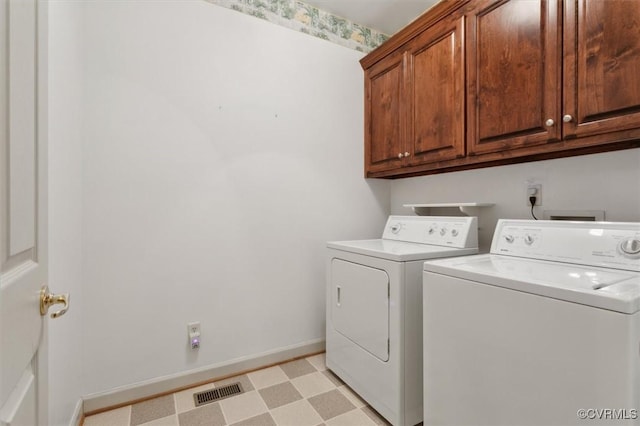 laundry area featuring cabinet space, visible vents, baseboards, light floors, and washing machine and dryer