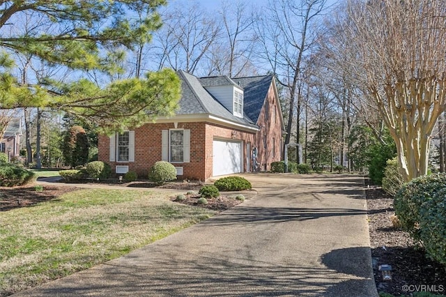 view of side of home with driveway, a shingled roof, a garage, and brick siding