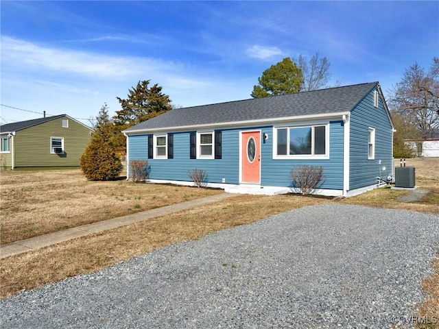 ranch-style home featuring central AC unit and a front lawn