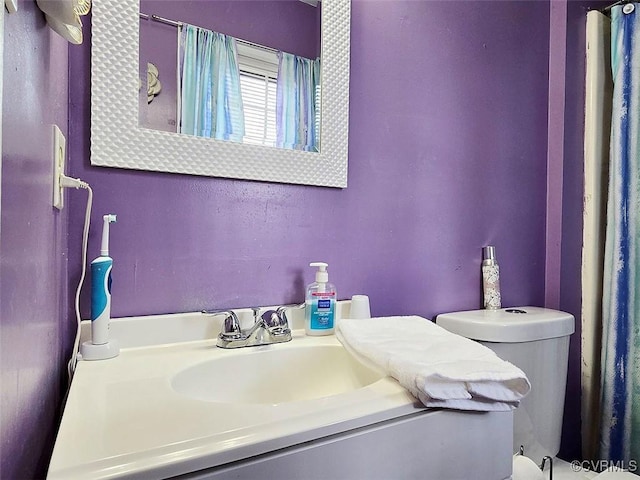 bathroom with toilet and vanity