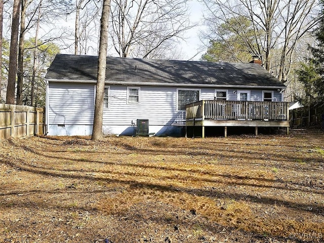 rear view of house featuring central air condition unit and a wooden deck