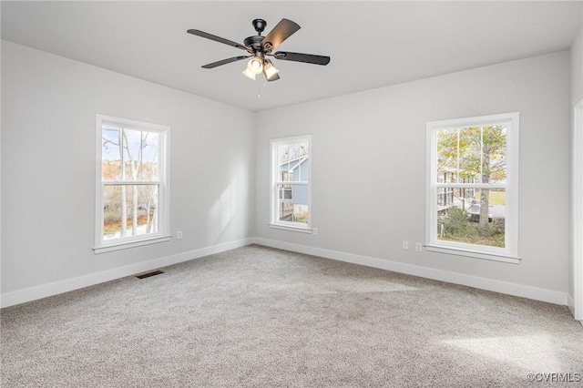 empty room with ceiling fan and carpet flooring