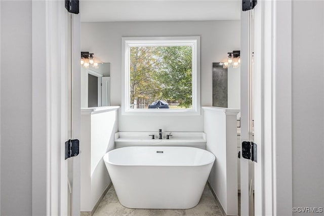 bathroom with a tub to relax in